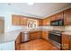 Updated kitchen features oak cabinets, modern stainless steel appliances and a bright, neutral decor at 8259 Camelia Ln, Denver, NC 28037