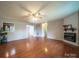 Spacious living room features hardwood floors, a ceiling fan, and a cozy fireplace at 8259 Camelia Ln, Denver, NC 28037