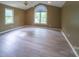 Open main bedroom with high ceilings, arched window, and ample natural light at 8259 Camelia Ln, Denver, NC 28037