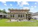 Inviting backyard patio featuring a wooden pergola and an outdoor seating area perfect for entertaining guests at 9009 Myrna Dr, Gastonia, NC 28056