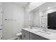 Bathroom features double sinks with granite countertops, a shower, and a large mirror at 9009 Myrna Dr, Gastonia, NC 28056