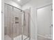 A tiled shower with glass doors, a built-in shower bench, and a niche provide a luxurious bathroom experience at 9009 Myrna Dr, Gastonia, NC 28056