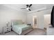 Bedroom featuring a bed, ceiling fan, carpet flooring and an attached bathroom at 9009 Myrna Dr, Gastonia, NC 28056