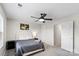 Cozy bedroom features a ceiling fan, two windows, carpeted floors, and neutral wall decor at 9009 Myrna Dr, Gastonia, NC 28056