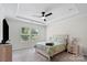 Bright bedroom with a ceiling fan, two windows, tray ceiling, and neutral decor at 9009 Myrna Dr, Gastonia, NC 28056