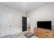 Bedroom with neutral walls, carpet, and a wood dresser with mounted TV at 9009 Myrna Dr, Gastonia, NC 28056