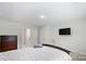 Bedroom featuring a comfortable bed, a mounted television, a dresser, and two entry doors at 9009 Myrna Dr, Gastonia, NC 28056