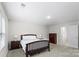 Bedroom with a comfy bed, soft carpet, natural lighting, and dark-stained nightstands and dresser at 9009 Myrna Dr, Gastonia, NC 28056