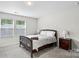 Cozy bedroom with a comfortable bed, two windows bringing in natural light, and dark-stained nightstands at 9009 Myrna Dr, Gastonia, NC 28056