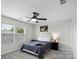 Comfortable bedroom with a ceiling fan, ample natural light from two windows, and neutral wall decor at 9009 Myrna Dr, Gastonia, NC 28056
