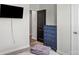 Bedroom showcasing wood-look floors, closet space and a mounted TV at 9009 Myrna Dr, Gastonia, NC 28056