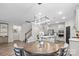 Elegant dining area with a modern chandelier, hardwood floors, and views of the kitchen, perfect for Gathering gatherings at 9009 Myrna Dr, Gastonia, NC 28056