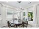 Bright dining area with hardwood floors, a modern chandelier, and sliding glass doors leading to the patio at 9009 Myrna Dr, Gastonia, NC 28056