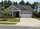 Charming gray home featuring a well-manicured lawn, a two-car garage, and a covered front porch entry at 9009 Myrna Dr, Gastonia, NC 28056