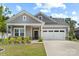 Charming single-story home featuring a well-manicured lawn, a two-car garage, and a welcoming front porch at 9009 Myrna Dr, Gastonia, NC 28056