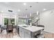 Bright kitchen featuring a center island, pendant lighting, and an open floor plan connecting to a dining area and living space at 9009 Myrna Dr, Gastonia, NC 28056
