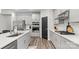 Bright kitchen featuring white countertops, gray cabinets, stainless appliances, and a dark accent door at 9009 Myrna Dr, Gastonia, NC 28056