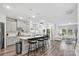 Well-lit kitchen boasts gray cabinets, stainless steel appliances, a center island with bar stools, and hardwood flooring at 9009 Myrna Dr, Gastonia, NC 28056