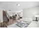 Open-concept living room with hardwood flooring, a staircase, and a glimpse of the kitchen, perfect for entertaining at 9009 Myrna Dr, Gastonia, NC 28056