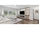 Cozy living room with built-in shelving, a fireplace, and large windows, creating an inviting atmosphere at 9009 Myrna Dr, Gastonia, NC 28056