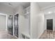 Bright mudroom features storage cubbies, hooks, bench, and access to a hallway and black interior door at 9009 Myrna Dr, Gastonia, NC 28056