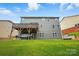Back exterior of a two-story home with a spacious deck overlooking the backyard at 9511 Spurwig Ct, Charlotte, NC 28278
