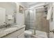 Tiled bathroom featuring a glass-enclosed shower and granite countertop sink at 9511 Spurwig Ct, Charlotte, NC 28278