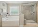 Bathroom with large bathtub and glass-enclosed shower, offering a spa-like experience at 9511 Spurwig Ct, Charlotte, NC 28278