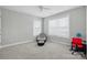 Neutral bedroom with an air chair and a desk setup, flooded with natural light at 9511 Spurwig Ct, Charlotte, NC 28278