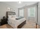 Serene bedroom with a comfortable bed, soft carpet, and windows dressed with white curtains at 9511 Spurwig Ct, Charlotte, NC 28278