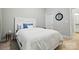 Well-lit bedroom with a white bed and calming blue accents at 9511 Spurwig Ct, Charlotte, NC 28278