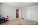 Neutral bedroom with ceiling fan, closet, and access to other rooms, providing comfort at 9511 Spurwig Ct, Charlotte, NC 28278