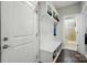 Well-organized entryway with built-in storage bench, hooks, and a view into the adjacent bathroom at 9511 Spurwig Ct, Charlotte, NC 28278