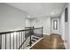 Hallway with hardwood floors, and black wrought iron railing with access to other rooms at 9511 Spurwig Ct, Charlotte, NC 28278