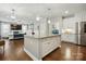 Open concept kitchen featuring a large island and seamless connection to living area at 9511 Spurwig Ct, Charlotte, NC 28278