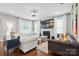 Bright living room featuring hardwood floors, a fireplace, and large windows letting in natural light at 9511 Spurwig Ct, Charlotte, NC 28278