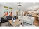Open-concept living room with stylish decor, leading to a modern kitchen with white cabinets at 9511 Spurwig Ct, Charlotte, NC 28278