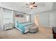 Light-filled main bedroom with a tray ceiling, fan, and ensuite bathroom for convenience at 9511 Spurwig Ct, Charlotte, NC 28278