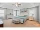Spacious main bedroom with tray ceiling, fan, and matching dressers, bathed in natural light at 9511 Spurwig Ct, Charlotte, NC 28278