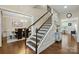 Open staircase with dark wood handrail, leading to the upper level at 9511 Spurwig Ct, Charlotte, NC 28278