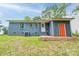 Charming single-story brick home featuring a bright orange door and a well-maintained backyard at 1010 Fallston Rd, Shelby, NC 28150