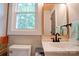 Bathroom with stylish vanity, mirror, toilet and bright natural light at 1010 Fallston Rd, Shelby, NC 28150