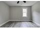 Bright bedroom featuring hardwood floors and a sun-filled window at 1010 Fallston Rd, Shelby, NC 28150