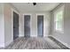 Bedroom with updated flooring, gray walls, and two closet doors at 1010 Fallston Rd, Shelby, NC 28150