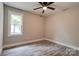 Bedroom featuring hardwood floors, window with outside view, and ceiling fan at 1010 Fallston Rd, Shelby, NC 28150