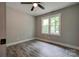 This bedroom features neutral walls, hardwood floors, a ceiling fan, and a window at 1010 Fallston Rd, Shelby, NC 28150