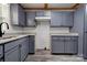 Well-appointed kitchen featuring gray cabinets, granite counters, and stainless steel sink at 1010 Fallston Rd, Shelby, NC 28150