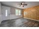 Inviting living room featuring light gray walls, a wood accent wall, and a window with natural light at 1010 Fallston Rd, Shelby, NC 28150