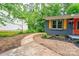 Quaint home with a paved walkway, stone landscape trim, and mature trees at 1010 Fallston Rd, Shelby, NC 28150