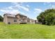 Large backyard with a lawn and house with solar panels at 10198 Tintinhull Dr, Fort Mill, SC 29707